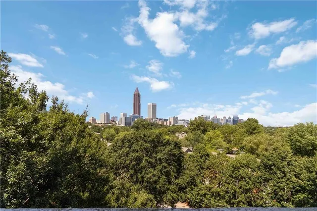 a view of a city with lush green forest