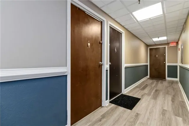 a view of hallway with wooden floor