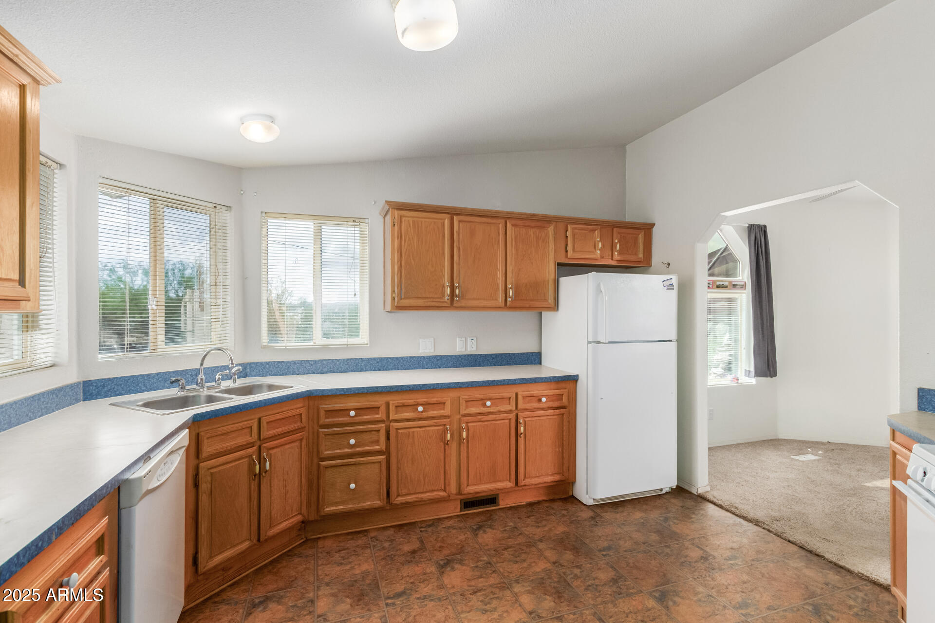 3130 West Lazy G Ranch Road New River, AZ 85087 - Photo 17 of 35 a kitchen with a sink a refrigerator and window