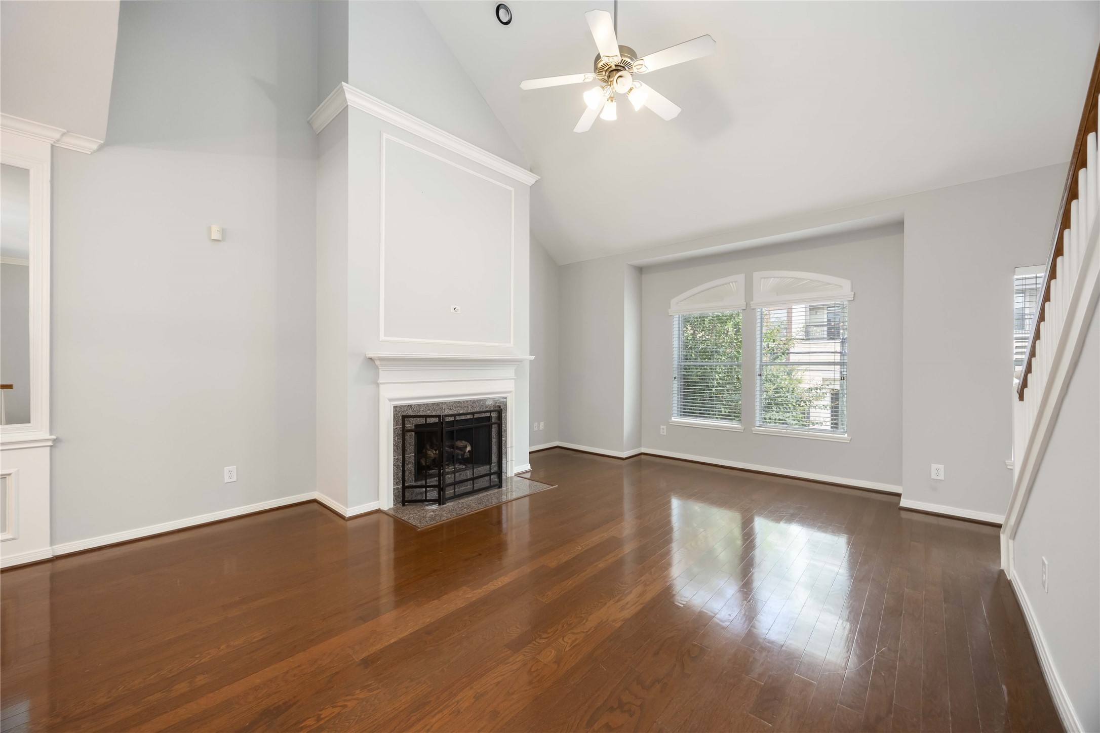 2909 West Dallas Street Houston, TX 77019 - Photo 14 of 39 an empty room with wooden floor fireplace and windows