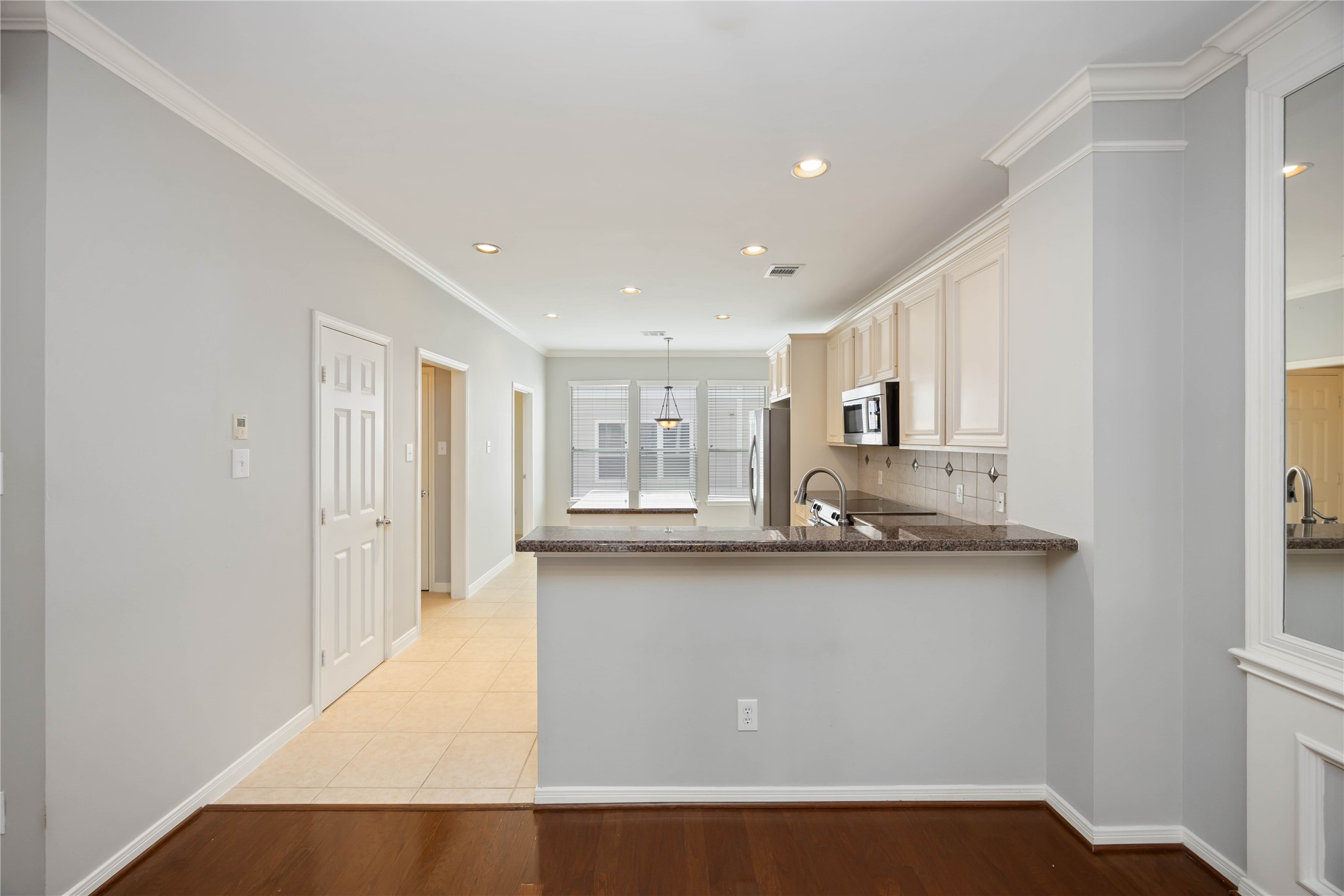 2909 West Dallas Street Houston, TX 77019 - Photo 17 of 39 a large white kitchen with stainless steel appliances granite countertop a sink and cabinets