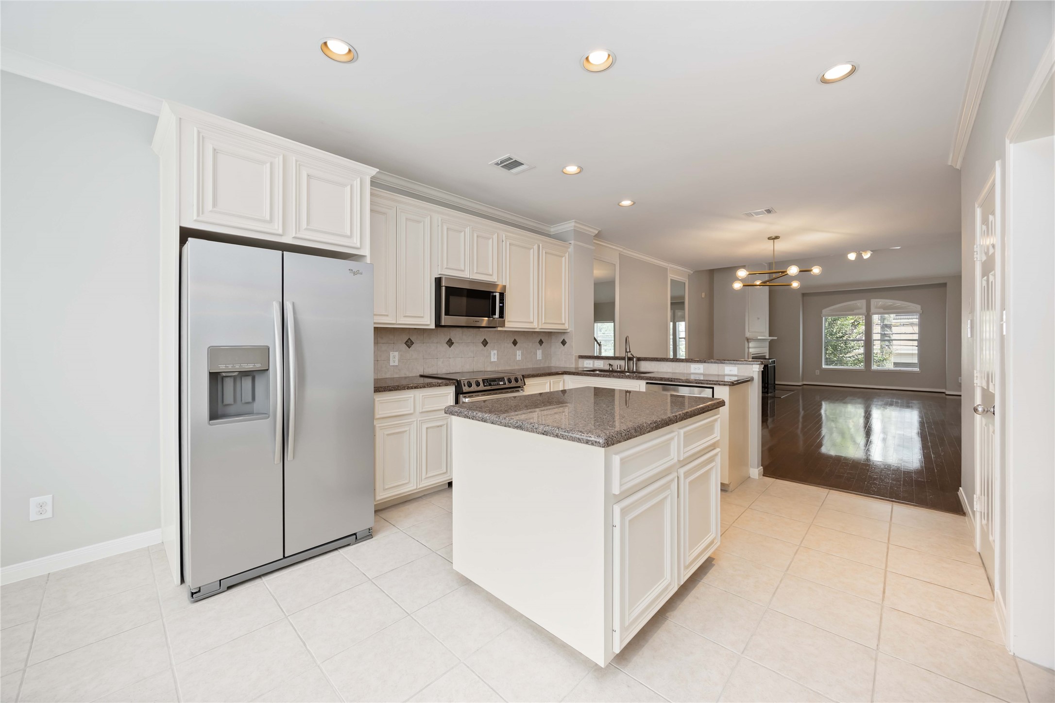 2909 West Dallas Street Houston, TX 77019 - Photo 22 of 39 a kitchen with white cabinets and refrigerator