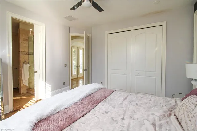 a bedroom with a bed and a lamp