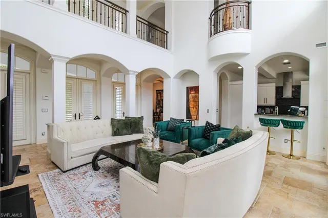 a living room with furniture potted plant and windows