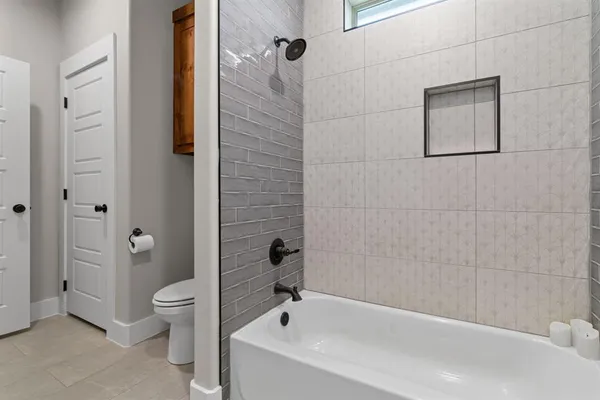 a bathroom with a bathtub and toilet