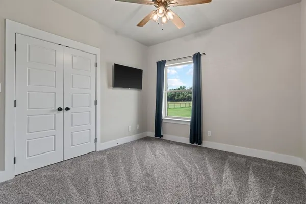 a view of a livingroom with an empty space and a window