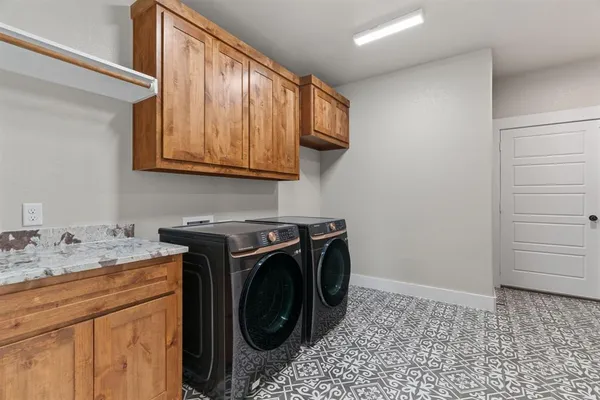 a utility room with sink dryer and washer