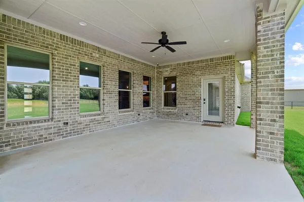 a view of a porch with a table and chairs