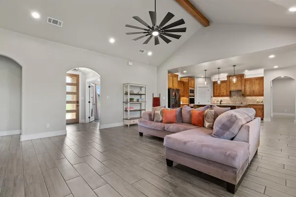 a living room with furniture and kitchen view