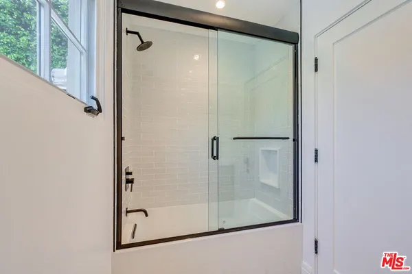 a bathroom with a glass shower door