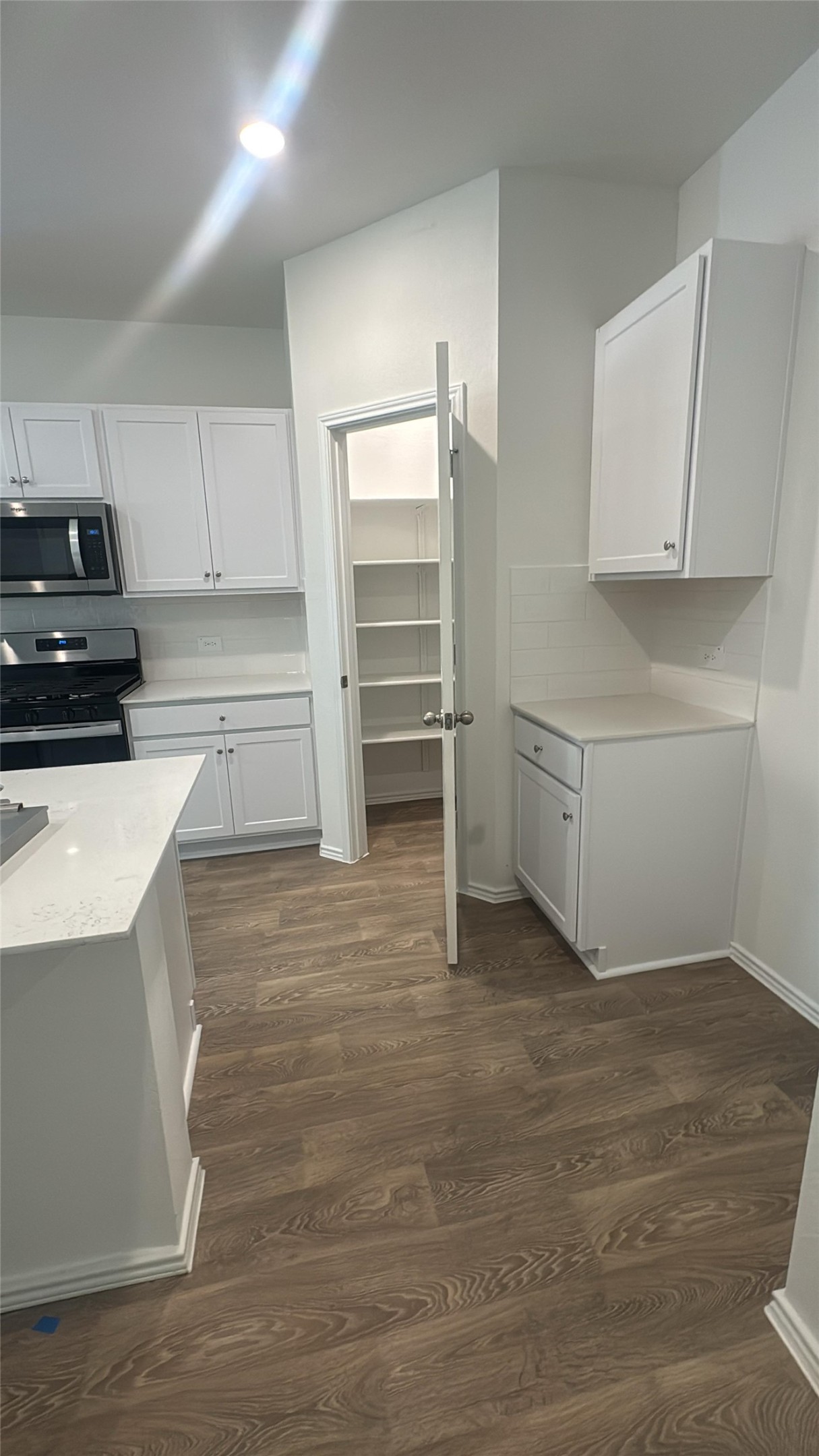 174 Balmorhea Street Kyle, TX 78640 - Photo 18 of 29 A well-lit kitchen with sleek appliances and ample pantry storage for culinary endeavors.
