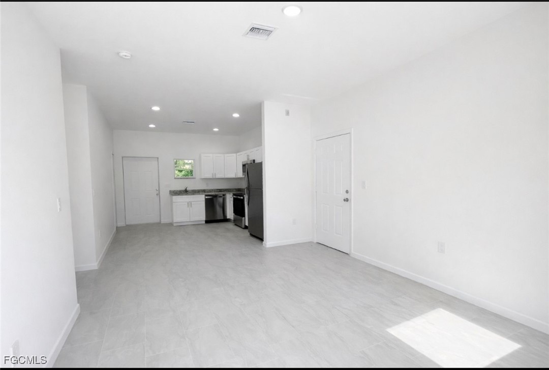 3121 24th Street Southwest Lehigh Acres, FL 33976 - Photo 2 of 10 a view of a livingroom with furniture and kitchen