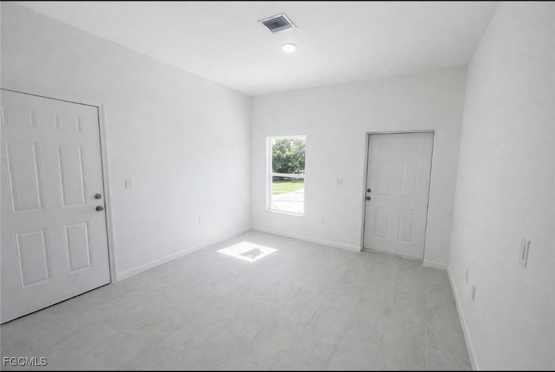 3121 24th Street Southwest Lehigh Acres, FL 33976 - Photo 3 of 10 a view of an empty room with a window