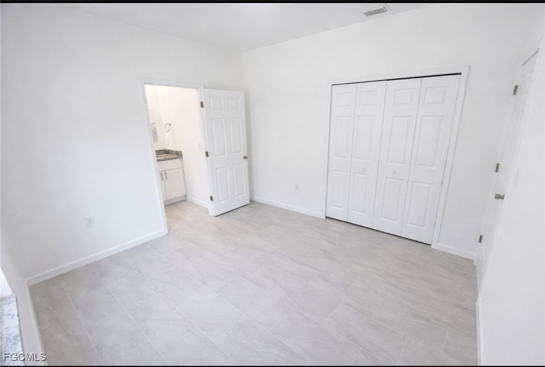 3121 24th Street Southwest Lehigh Acres, FL 33976 - Photo 9 of 10 a view of an empty room