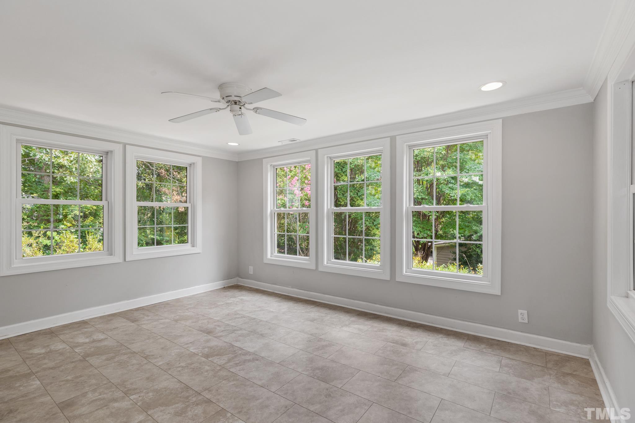6630 Winding Trail Raleigh, NC 27612 - Photo 13 of 33 an empty room with windows and natural light