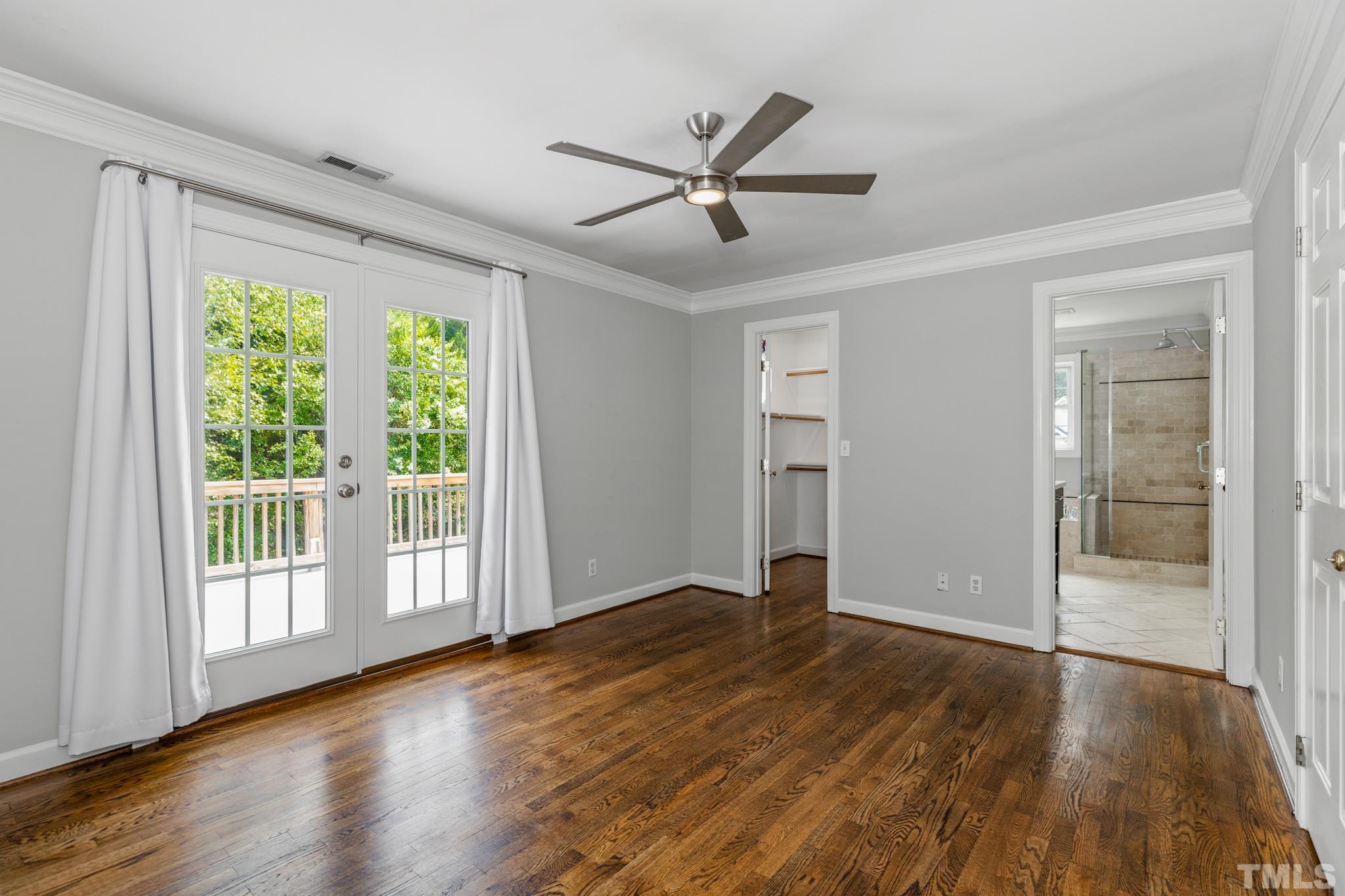 6630 Winding Trail Raleigh, NC 27612 - Photo 18 of 33 a view of an empty room with wooden floor and a window