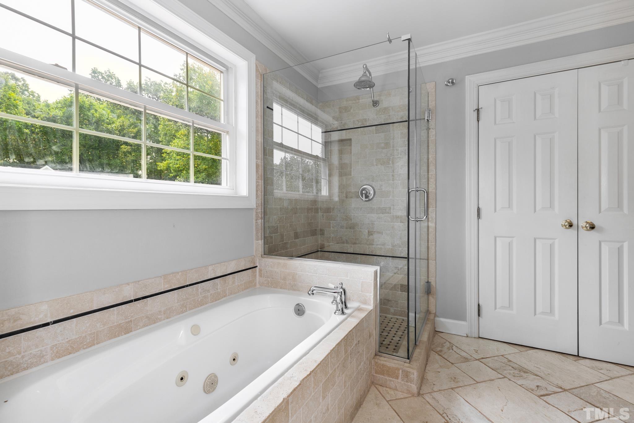6630 Winding Trail Raleigh, NC 27612 - Photo 22 of 33 a bathroom with a bathtub and a shower