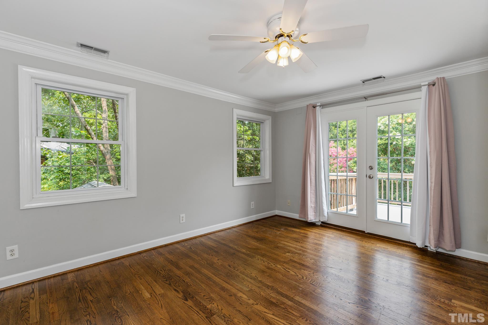 6630 Winding Trail Raleigh, NC 27612 - Photo 24 of 33 a view of an empty room with a window and wooden floor