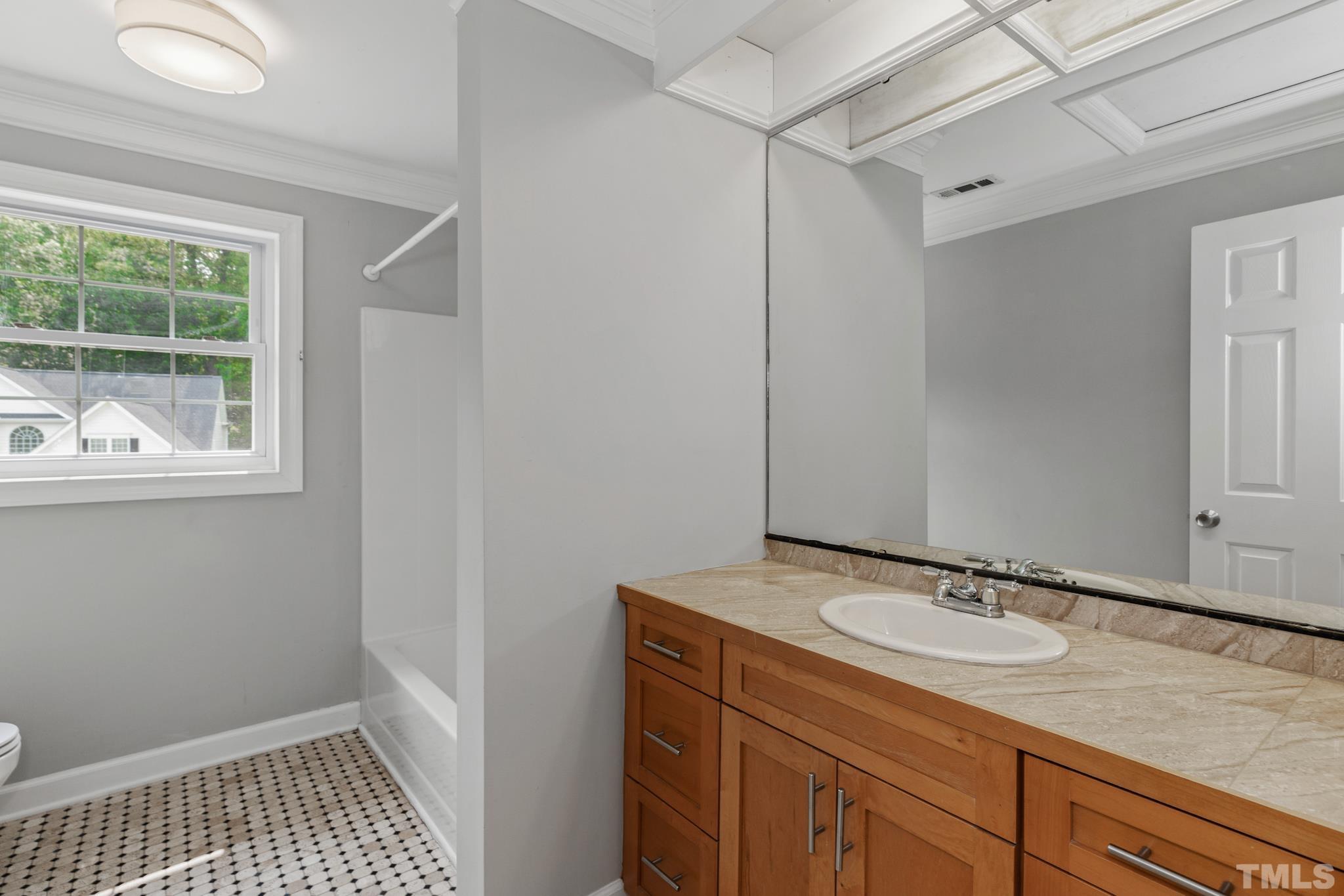 6630 Winding Trail Raleigh, NC 27612 - Photo 26 of 33 a bathroom with a sink and a mirror