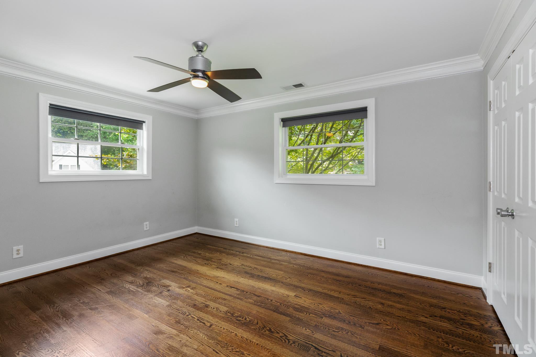 6630 Winding Trail Raleigh, NC 27612 - Photo 27 of 33 wooden floor in an empty room with a window
