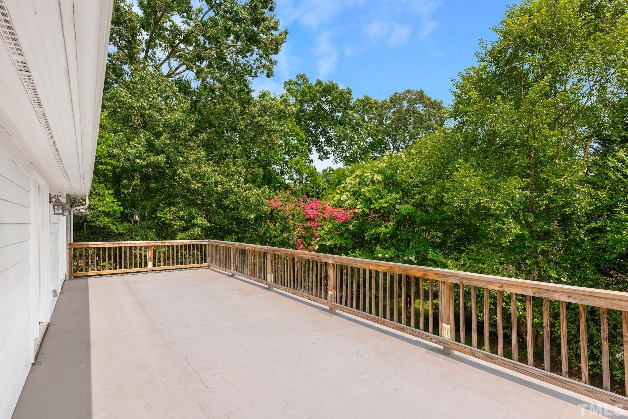 6630 Winding Trail Raleigh, NC 27612 - Photo 29 of 33 a view of a balcony with floor to ceiling window and tree