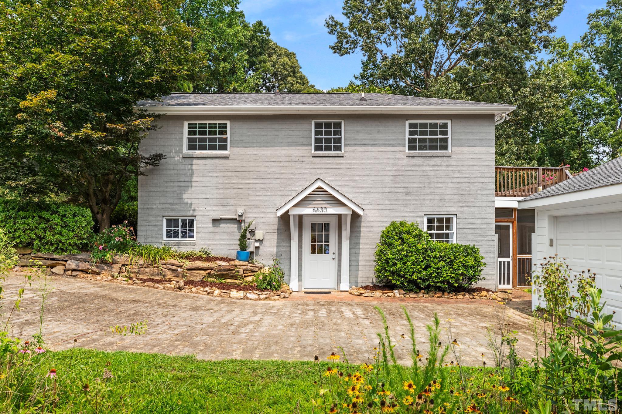 6630 Winding Trail Raleigh, NC 27612 - Photo 4 of 33 a front view of a house with a garden