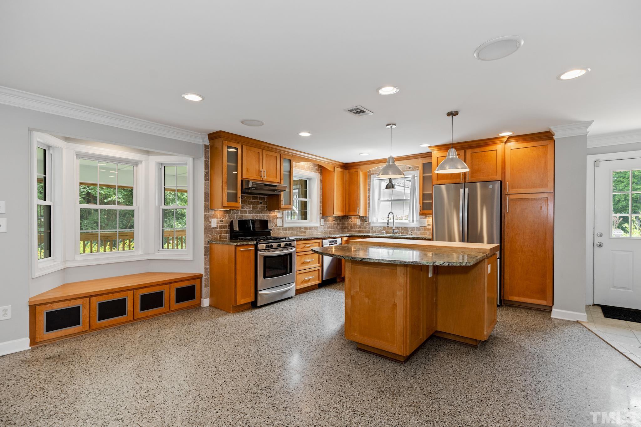 6630 Winding Trail Raleigh, NC 27612 - Photo 8 of 33 a kitchen with stainless steel appliances granite countertop a stove a sink and a refrigerator
