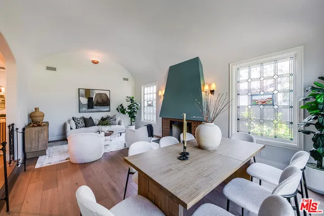 a living room with furniture a window and a lamp