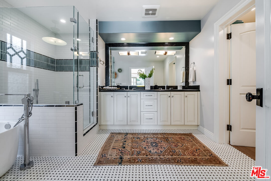 4359 Clybourn Avenue Toluca Lake, CA 91602 - Photo 19 of 45 a bathroom with a sink a toilet and shower