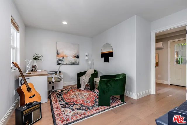 a living room with furniture and a mirror