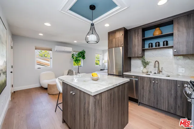 a kitchen with a sink stove and wooden floor