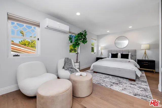 a bedroom with a bed and a couch