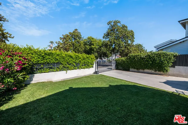 a view of yard with swimming pool and green space