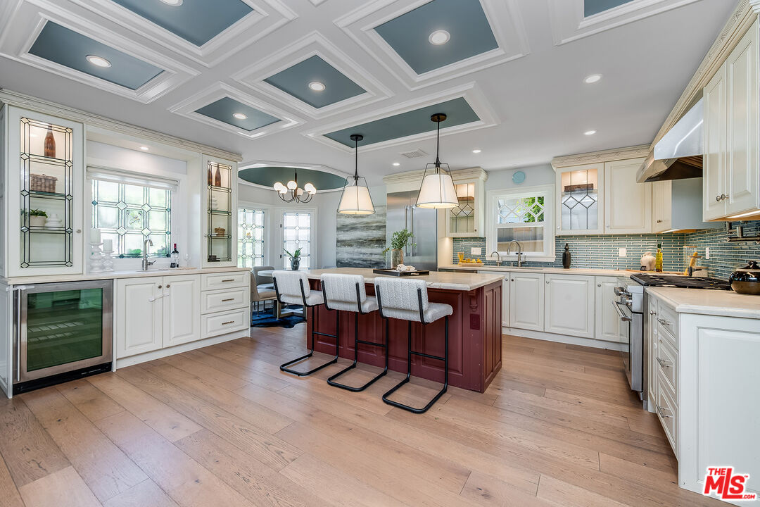 4359 Clybourn Avenue Toluca Lake, CA 91602 - Photo 8 of 45 a large white kitchen with lots of counter space and dining table