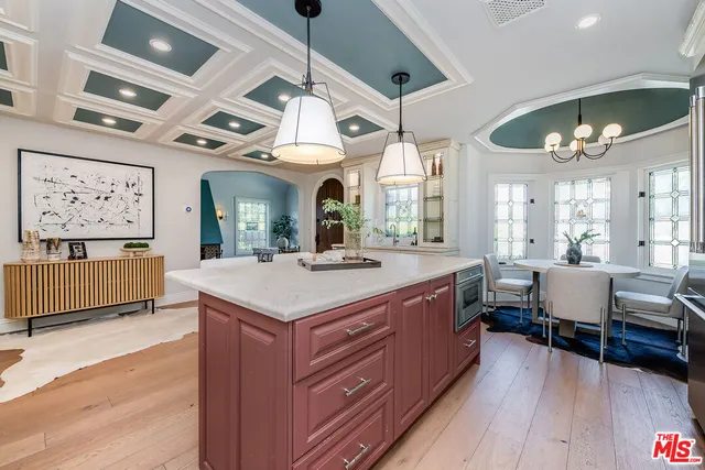 a large room with a large bed and wooden floor