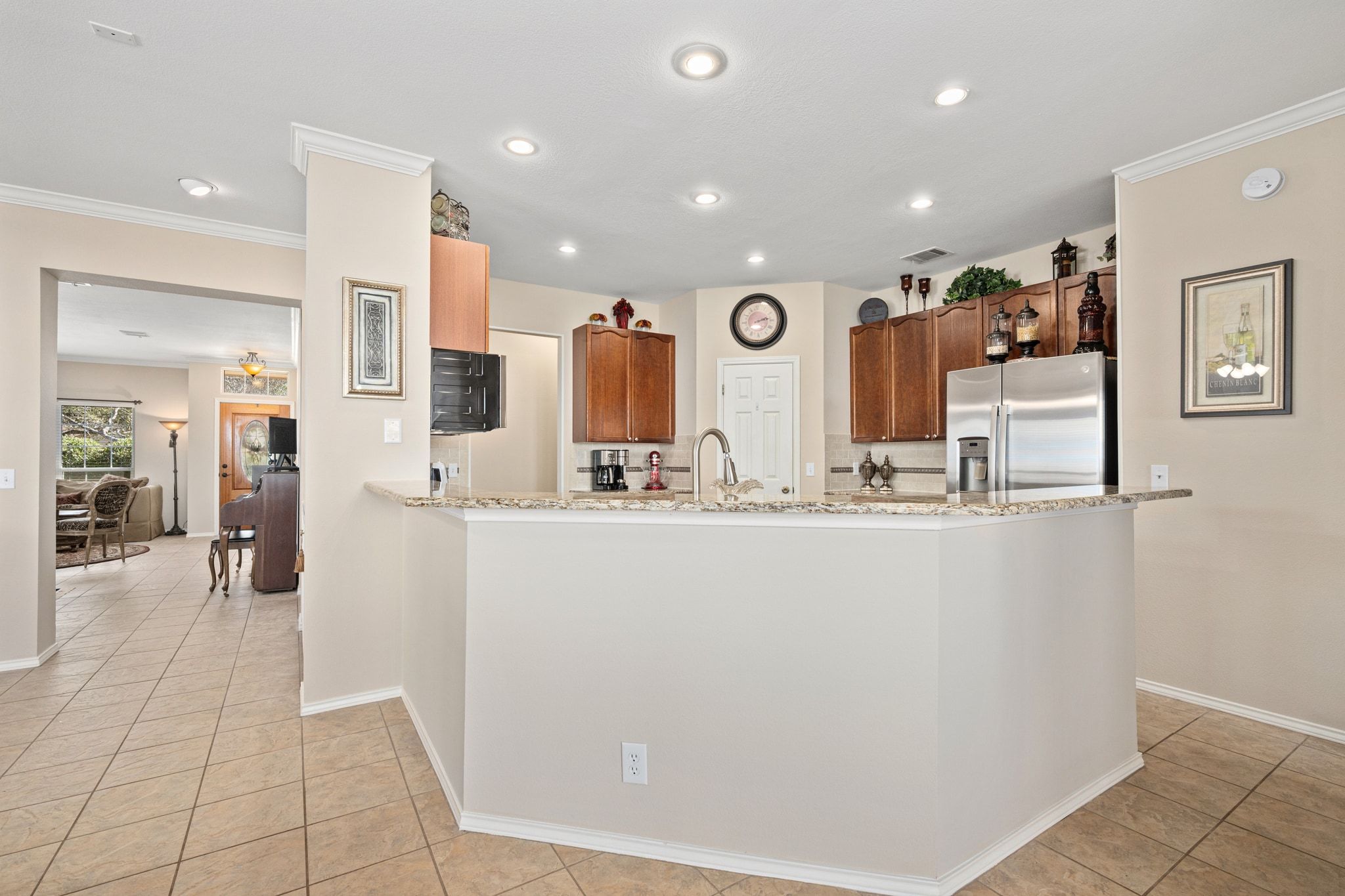 3312 Marin Court Austin, TX 78738 - Photo 15 of 40 The kitchen overlooks the family room for seamless connectivity with wraparound bar seating that is perfect for entertaining.