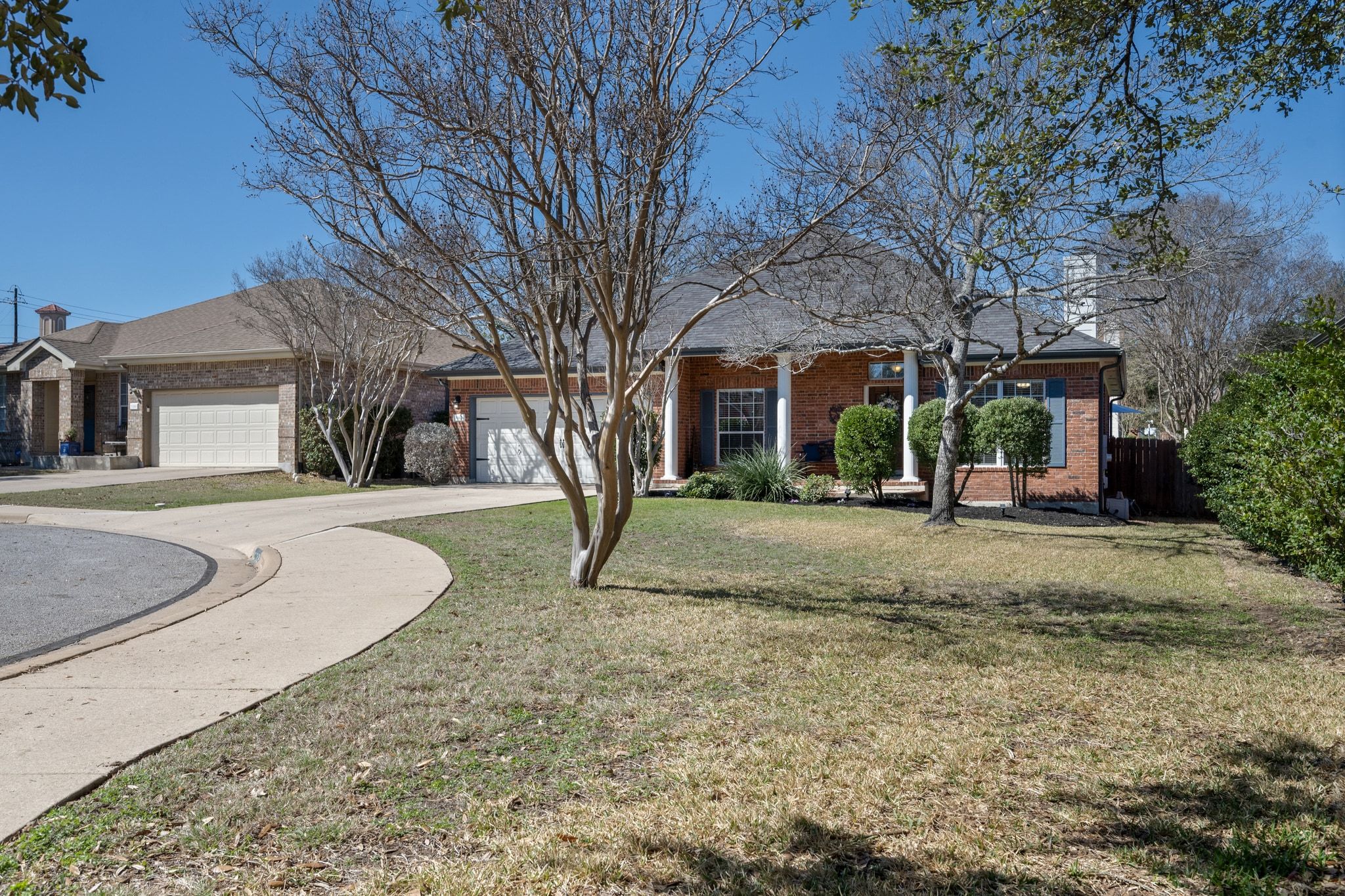 3312 Marin Court Austin, TX 78738 - Photo 7 of 40 Tucked away toward the end of the cul-de-sac, this striking home comes wrapped in beautiful mature landscaping with a two car garage.