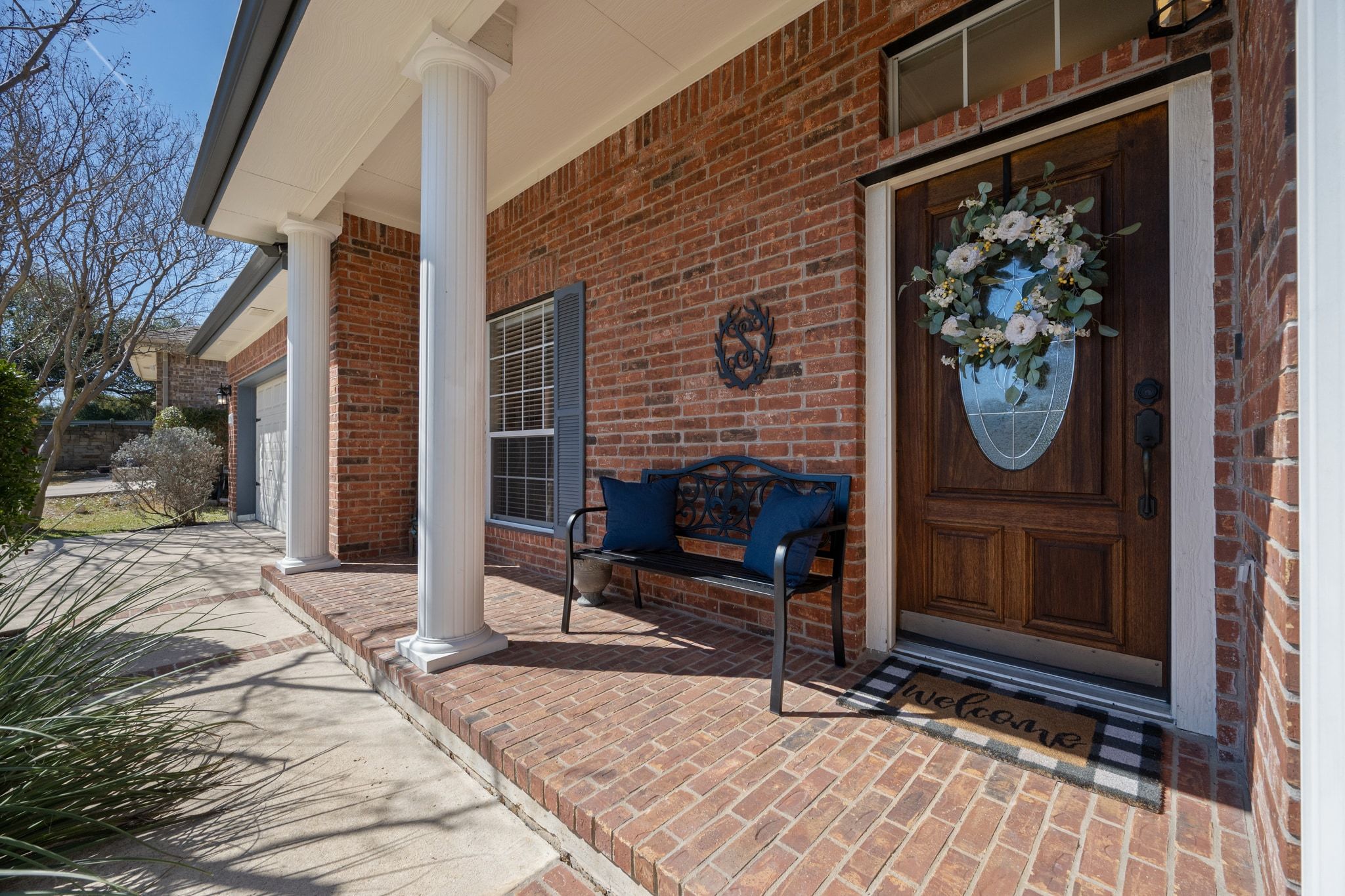 3312 Marin Court Austin, TX 78738 - Photo 8 of 40 The classic pillared front porch provides a covered space for a seating area and seasonal decor.