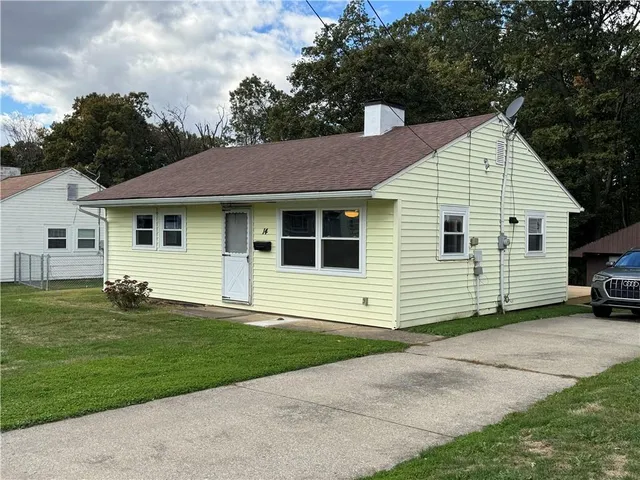 a view of a house with a yard and garage