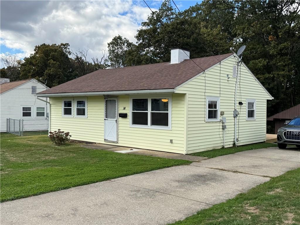 a view of a house with a yard and garage