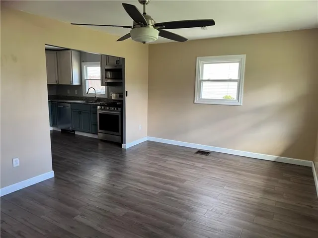 a view of kitchen with sink microwave and stove