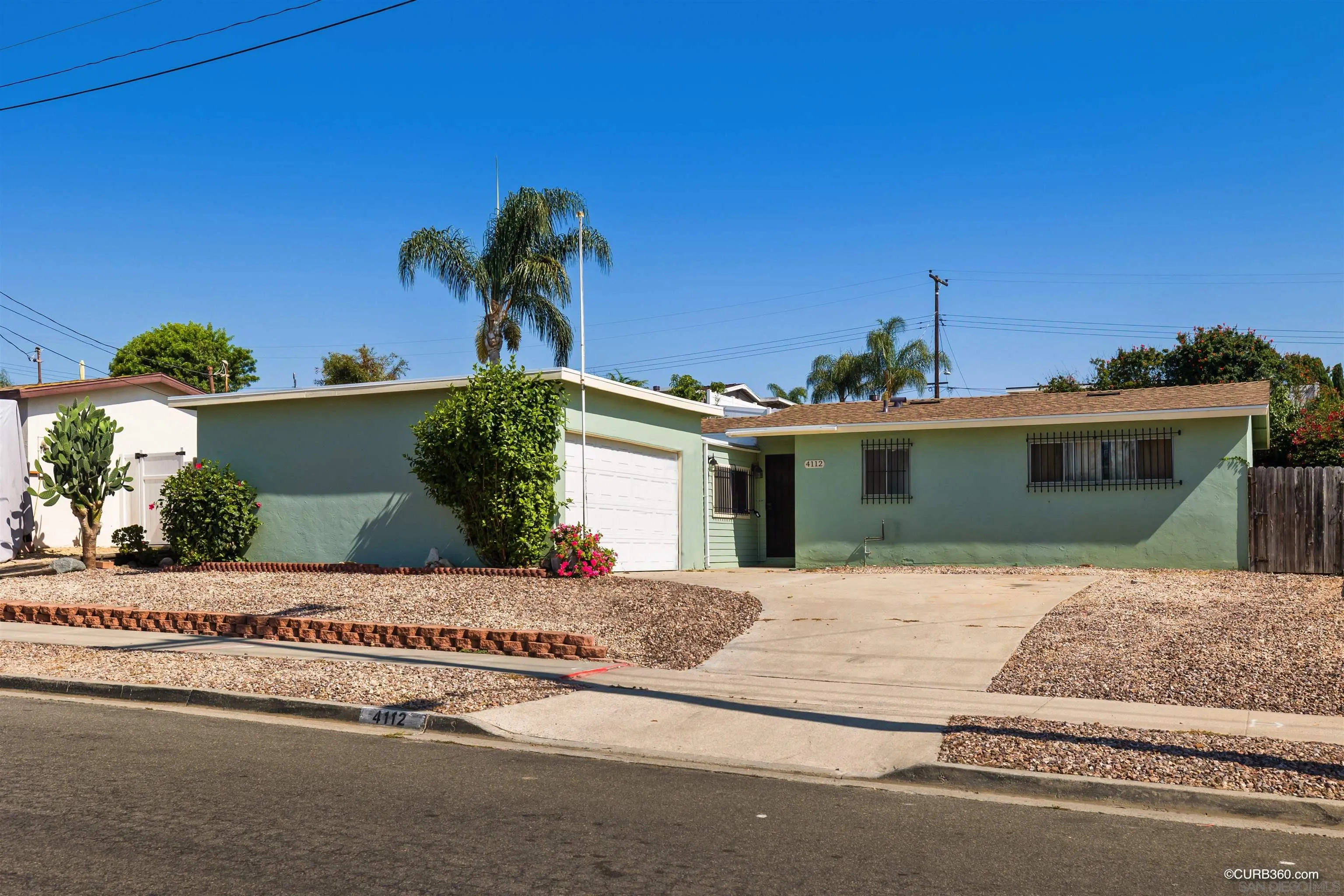 4112 Lewis Street Oceanside, CA 92056 - Photo 1 of 36 a front view of a house with a yard and a garage