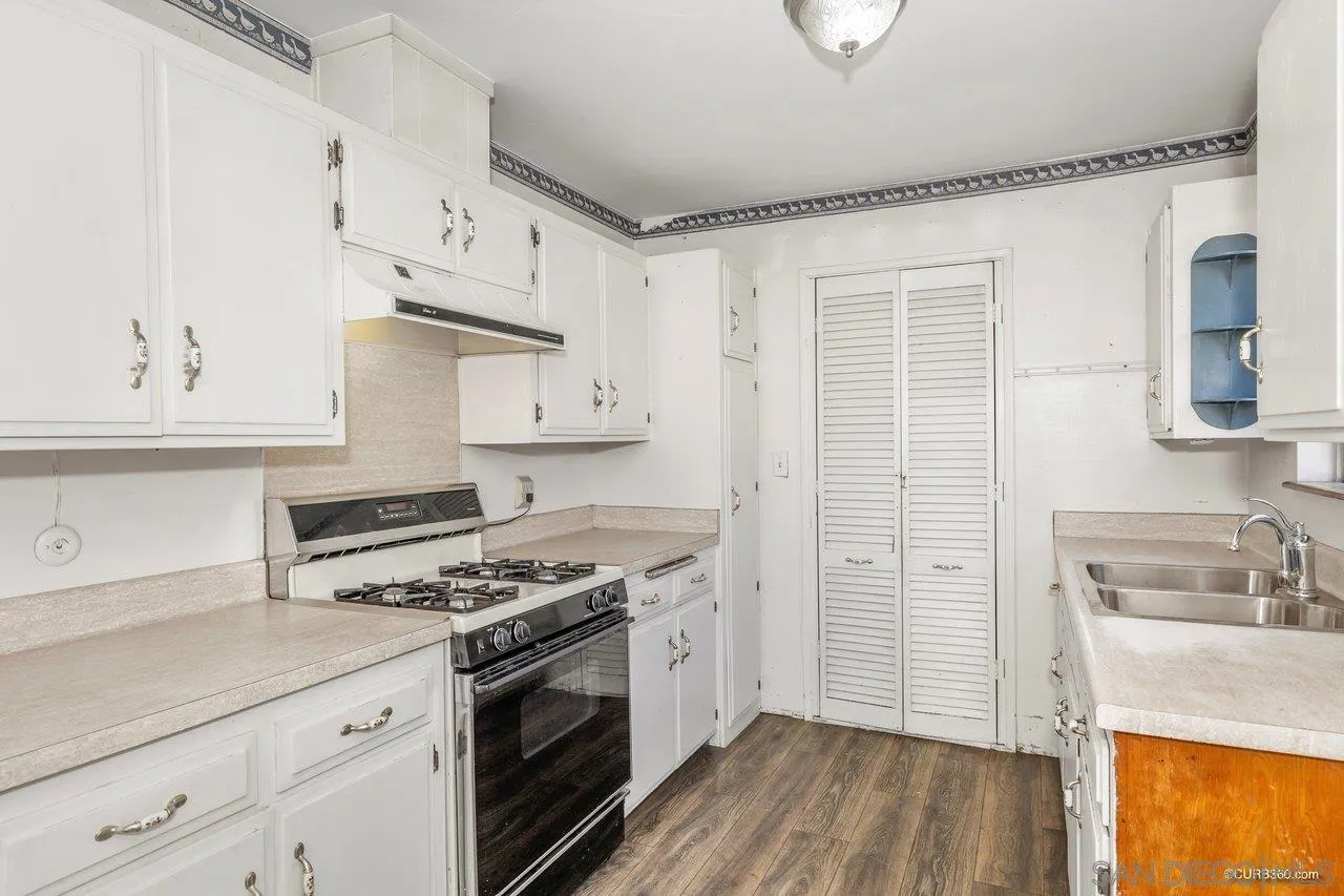 4112 Lewis Street Oceanside, CA 92056 - Photo 13 of 36 a kitchen with stainless steel appliances white cabinets and a stove