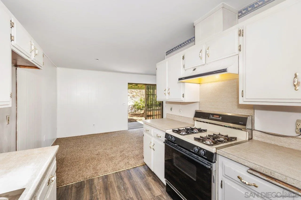 4112 Lewis Street Oceanside, CA 92056 - Photo 2 of 36 a kitchen with granite countertop a stove and a sink