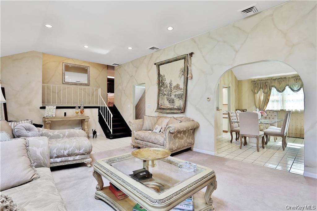 2 Split Tree Drive New Windsor, NY 12553 - Photo 11 of 36 Carpeted living room featuring recessed lighting, arched walkways, stairway, and tile patterned floors