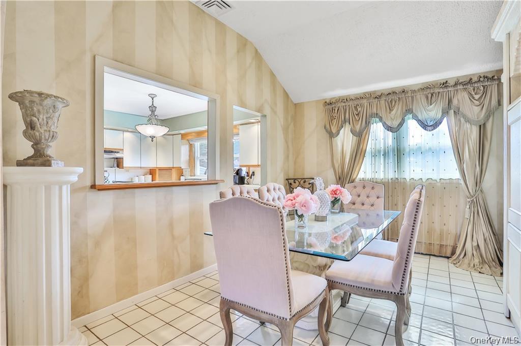 2 Split Tree Drive New Windsor, NY 12553 - Photo 16 of 36 Dining space with lofted ceiling, healthy amount of natural light, and light tile patterned flooring