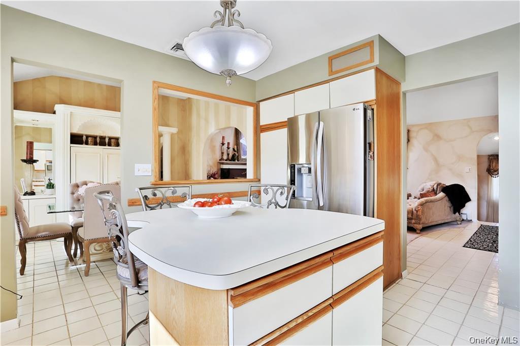 2 Split Tree Drive New Windsor, NY 12553 - Photo 19 of 36 Kitchen with white cabinets, stainless steel fridge with ice dispenser, light tile patterned flooring, and light countertops