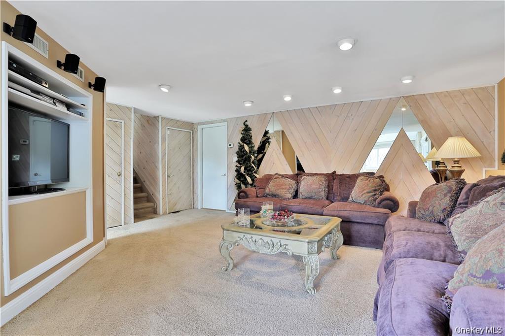 2 Split Tree Drive New Windsor, NY 12553 - Photo 26 of 36 Carpeted living area featuring wood walls and stairway