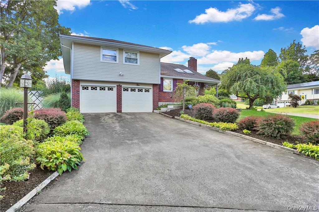 2 Split Tree Drive New Windsor, NY 12553 - Photo 4 of 36 View of front of home with brick siding, driveway, an attached garage, and a chimney