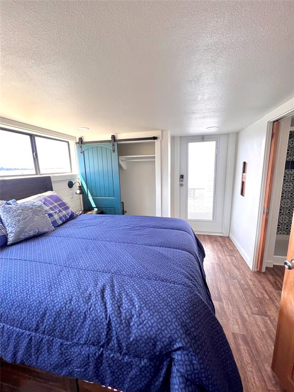 3235 County Road Cookville, TX 75558 - Photo 15 of 37 a bedroom with a bed and a mirror